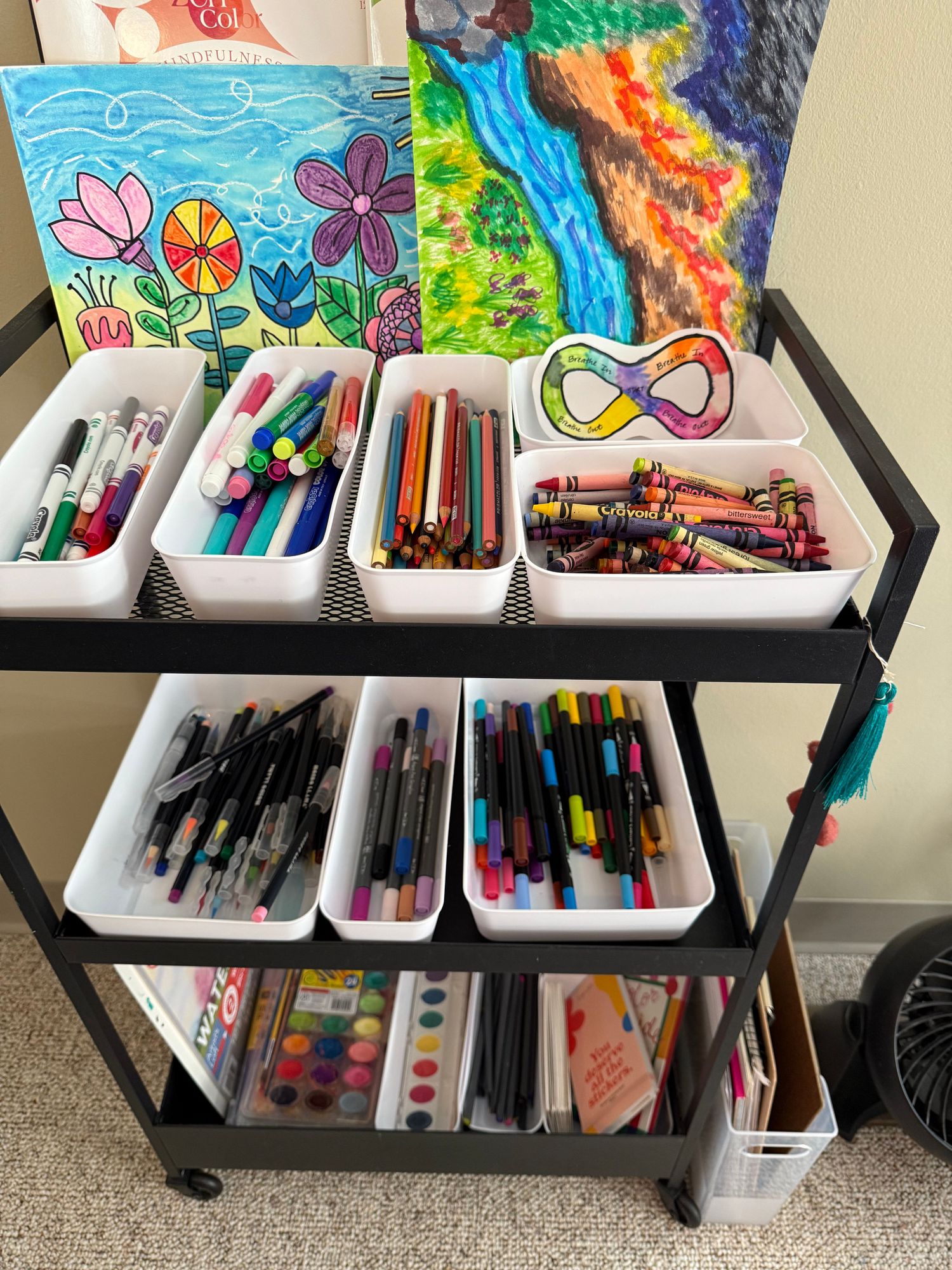 Art supply cart with markers, crayons, and creative materials for therapy sessions