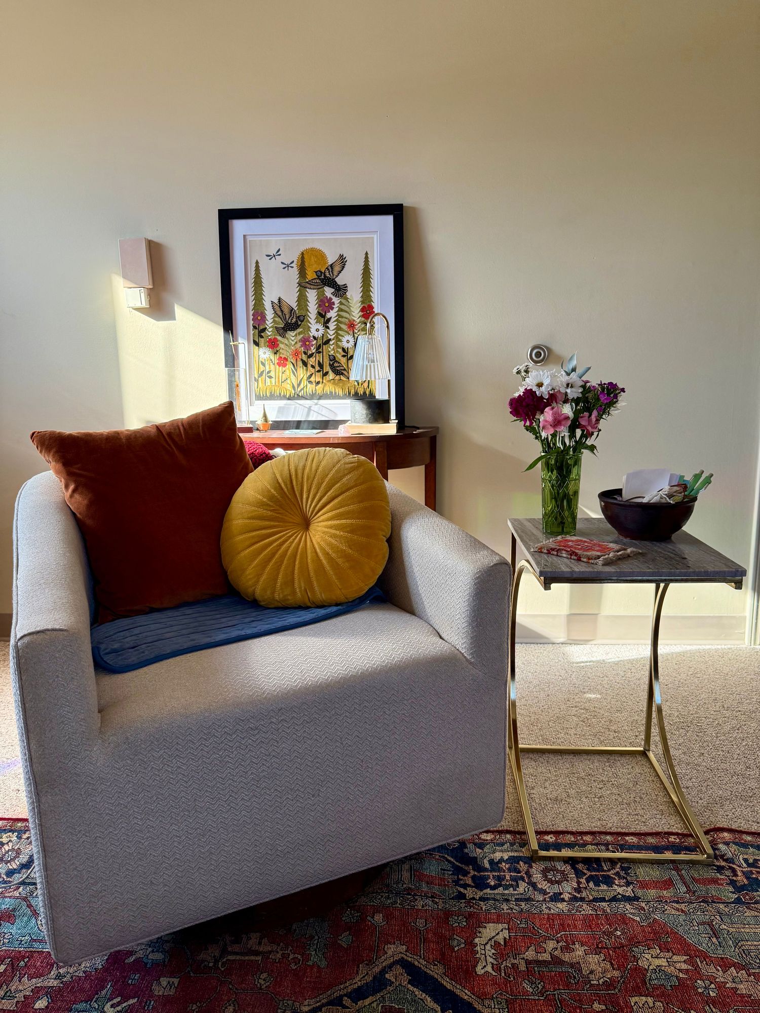 Comfortable bean bag with checkered blanket and rainbow light in therapy space